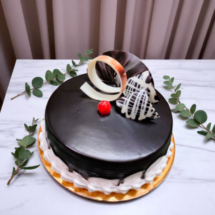 Choco Vanilla Crown Cake with chocolate glaze, cherry, and crown garnish