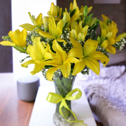 8 fresh Yellow Asiatic Lilies gracefully presented in a 10-inch transparent glass vase filled with white decorative - YHOJA.COM