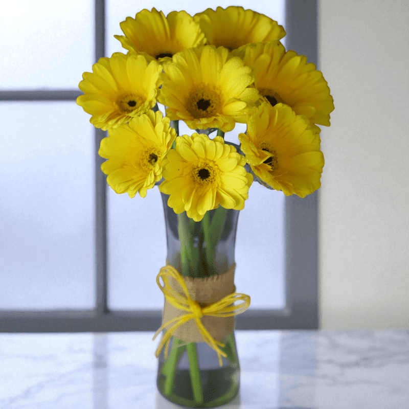 Yellow gerbera flower vase with rustic jute wrapping and ribbon bow