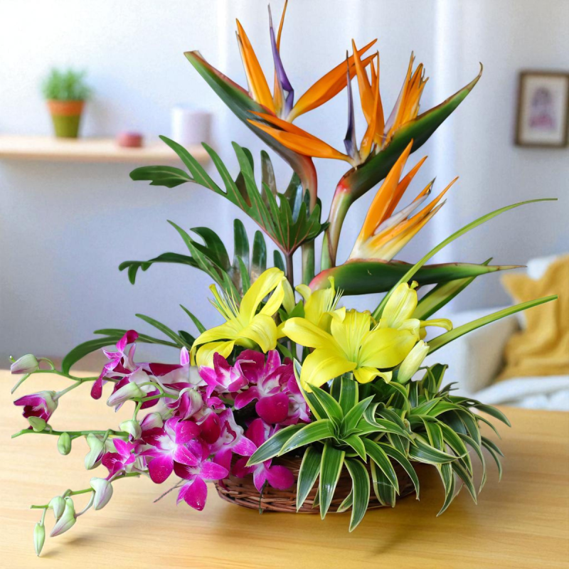 Tropical Charm Flower Basket with Bird of Paradise, lilies, and orchids arranged in a cane basket – ideal for gifting and décor.