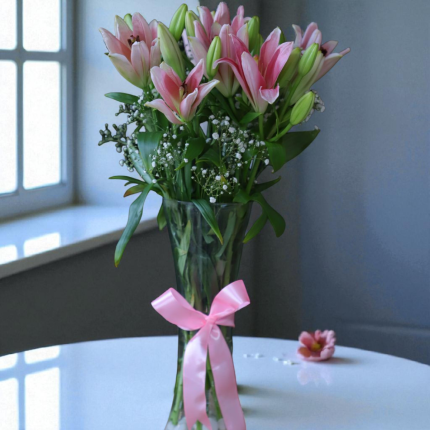 Pink asiatic lily vase arrangement with fillers and ribbon bow