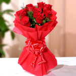 8 red roses bunch wrapped in red paper with ribbon bow