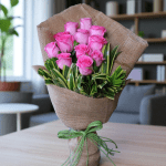 12 pink roses bouquet wrapped in jute with green ribbon