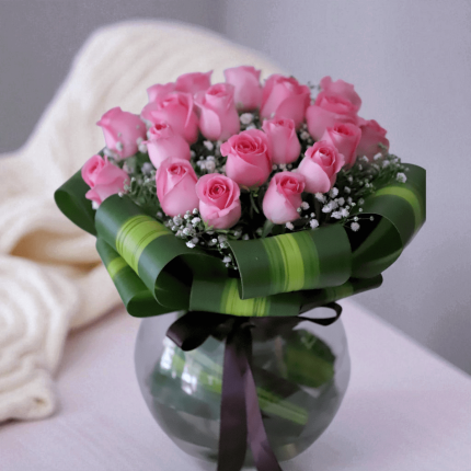 Pink roses glass vase arrangement with Victoria greens and fillers