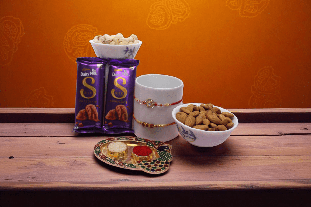 a Rudraksh Rakhi a sparkling Chakri Rakhi for a stylish touch. To sweeten the celebration, it includes two indulgent Cadbury Dairy Milk Silk bars and a premium dry fruit - YHOJA.COM