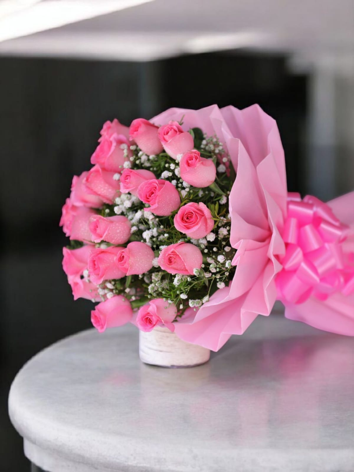 WhatsApp Image 2025-07-15 at 2.52.25 PM (1) Elegant bouquet of 20 pink roses with white filler in white paper wrap